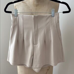 “Pleather” Women's Shorts. Back elastic. No waist. Front zip. Side pockets.